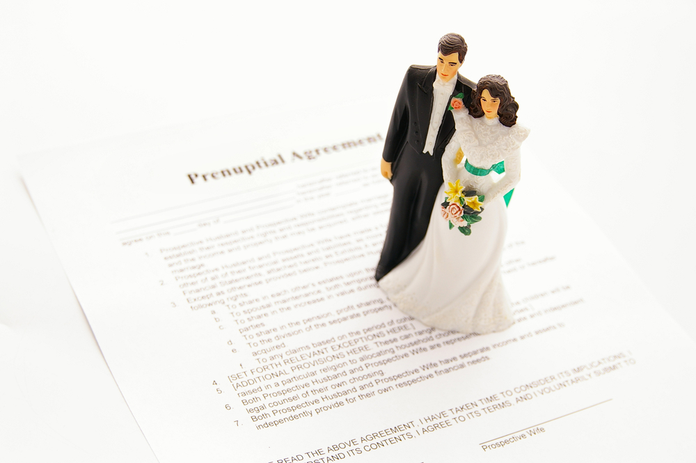cake-topper wedding couple and a pre-nuptial agreement