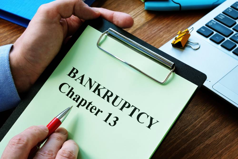 man reads bankruptcy chapter 13 law in the office