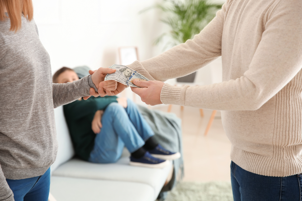 man giving alimony to his ex-wife at home