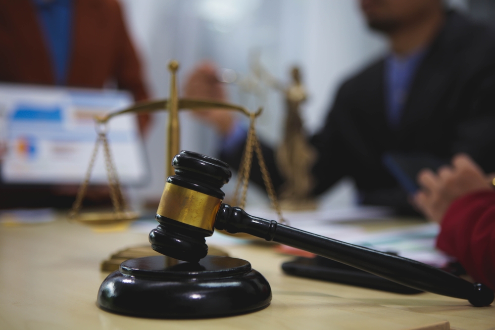 Lawyers in a meeting discuss case strategies, review evidence, prepare arguments, negotiate settlements